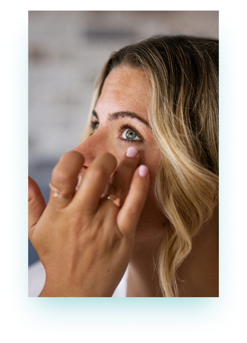 Woman applying eye drops